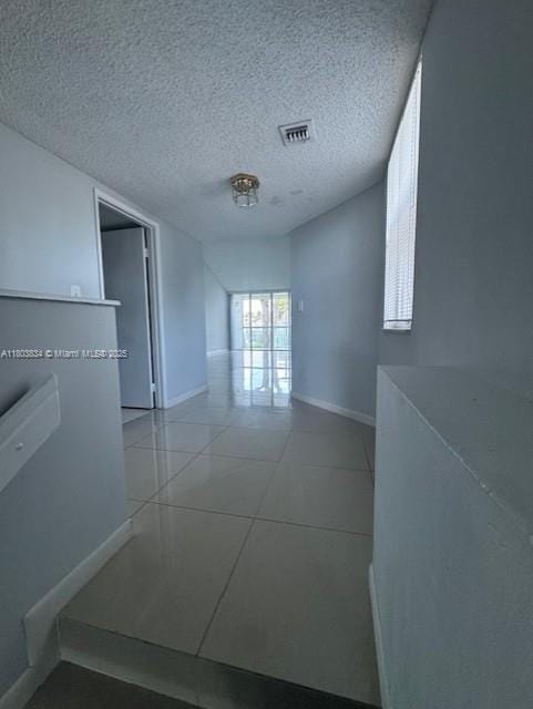 4724 NW 97th Ct Unit 87, Doral, FL 33178 - empty room featuring light tile patterned floors, baseboards, and a textured ceiling