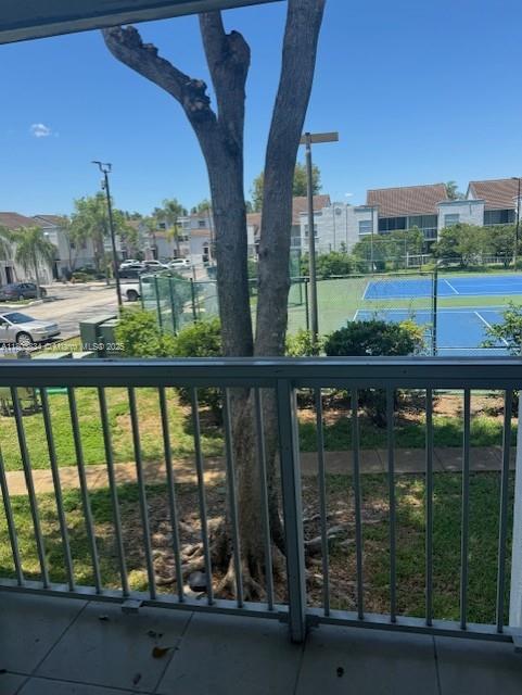 4724 NW 97th Ct Unit 87, Doral, FL 33178 - balcony with a tennis court and a residential view