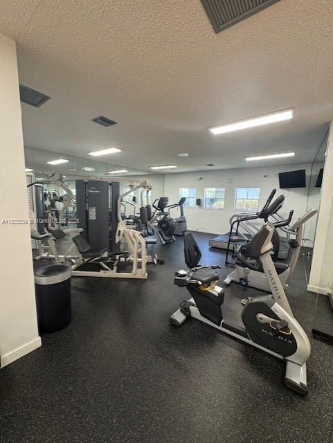 4724 NW 97th Ct Unit 87, Doral, FL 33178 - exercise room featuring a textured ceiling and baseboards