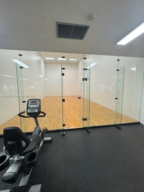 4724 NW 97th Ct Unit 87, Doral, FL 33178 - gym with a textured ceiling