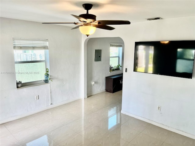 3135 SW 64th Ave, Miami, FL 33155 - empty room featuring ceiling fan, healthy amount of natural light, electric panel, and arched walkways