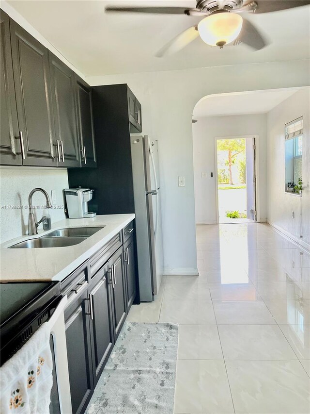 3135 SW 64th Ave, Miami, FL 33155 - kitchen with a sink, freestanding refrigerator, electric range, arched walkways, and ceiling fan