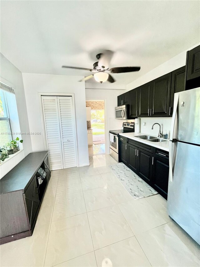3135 SW 64th Ave, Miami, FL 33155 - kitchen featuring appliances with stainless steel finishes, dark cabinetry, a sink, and plenty of natural light