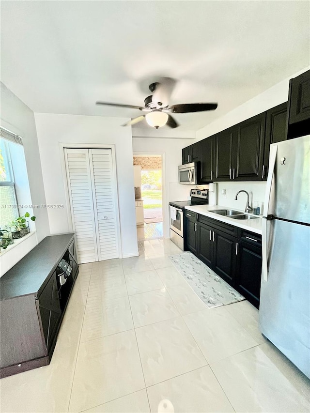 3135 SW 64th Ave, Miami, FL 33155 - kitchen with stainless steel appliances, dark cabinets, healthy amount of natural light, and ceiling fan