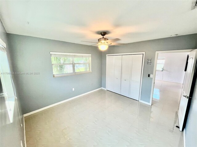 3135 SW 64th Ave, Miami, FL 33155 - unfurnished bedroom featuring a closet, baseboards, and a ceiling fan