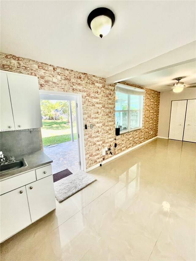 3135 SW 64th Ave, Miami, FL 33155 - unfurnished dining area with a sink, ceiling fan, and baseboards