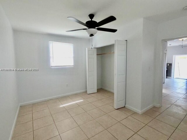 3135 SW 64th Ave, Miami, FL 33155 - unfurnished bedroom with light tile patterned flooring, baseboards, a closet, and a ceiling fan