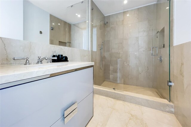 15701 Collins Ave Unit 3201, Sunny Isles Beach, FL 33160 - bathroom featuring a stall shower, vanity, recessed lighting, tile walls, and decorative backsplash