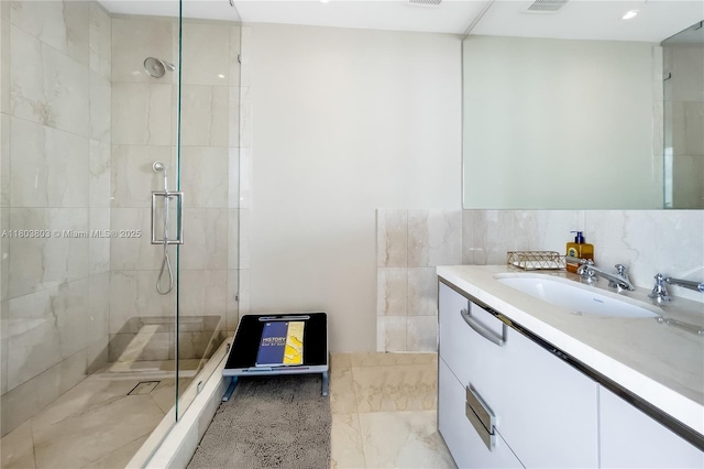 15701 Collins Ave Unit 3201, Sunny Isles Beach, FL 33160 - full bathroom with a shower stall, vanity, and tile walls