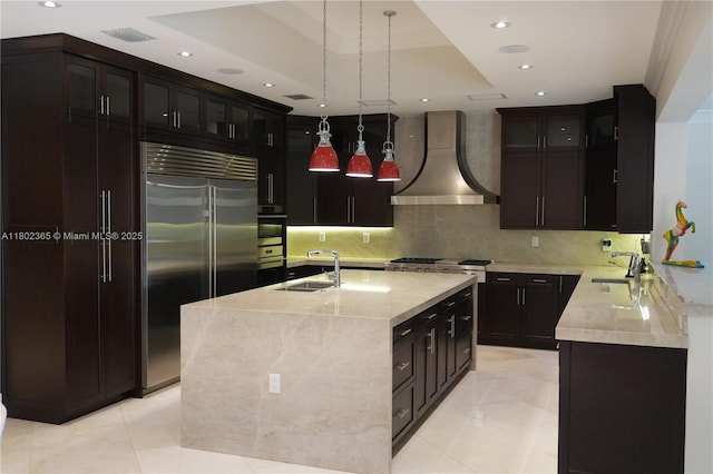 7740 SW 79th Ct, Miami, FL 33143 - kitchen with premium range hood, appliances with stainless steel finishes, a sink, recessed lighting, and a kitchen island with sink