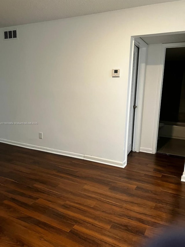 203 Lake Pointe Dr Unit 108, Oakland Park, FL 33309 - unfurnished room with dark wood-type flooring and baseboards