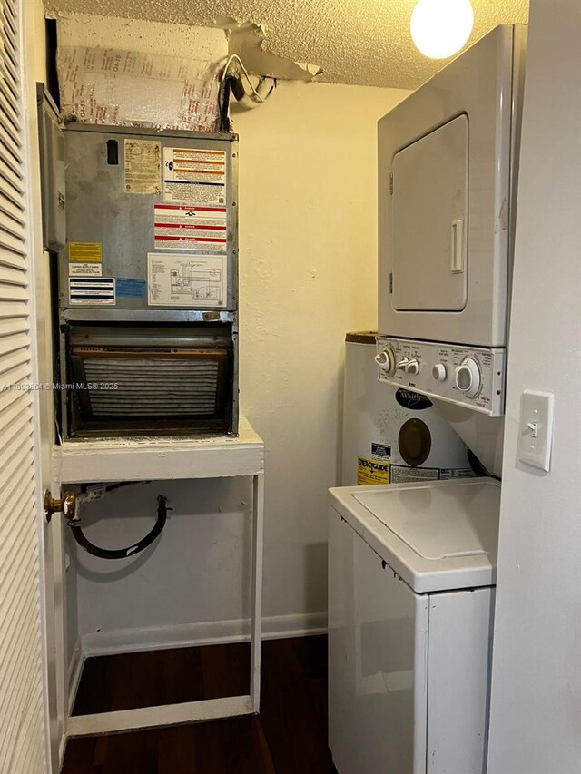 203 Lake Pointe Dr Unit 108, Oakland Park, FL 33309 - clothes washing area featuring stacked washer / drying machine and baseboards