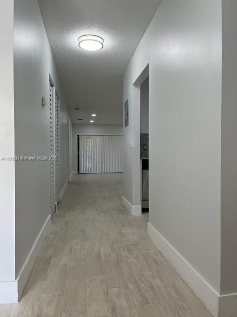 447 Lakeview Dr Unit 5, Weston, FL 33326 - hallway featuring baseboards and a textured ceiling