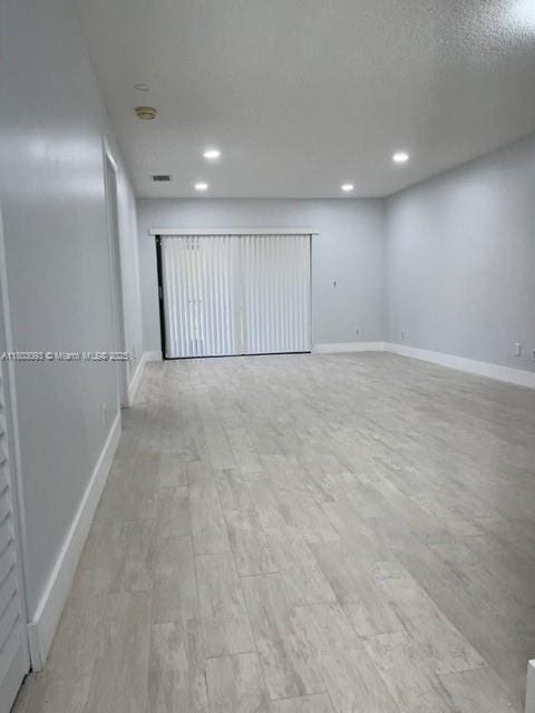447 Lakeview Dr Unit 5, Weston, FL 33326 - empty room with light wood-style flooring, baseboards, and recessed lighting