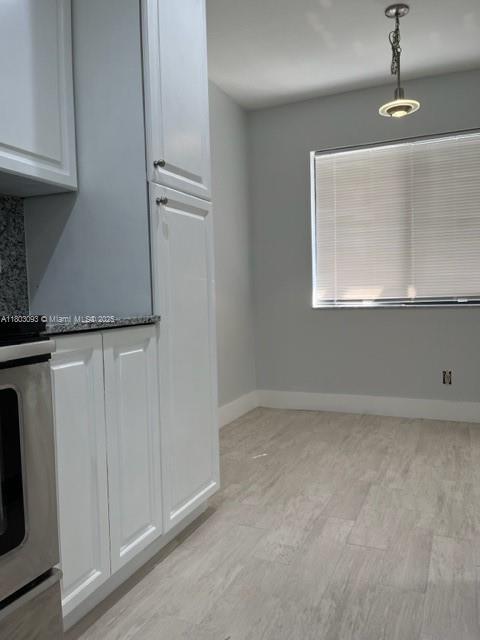 447 Lakeview Dr Unit 5, Weston, FL 33326 - unfurnished dining area with light wood finished floors and baseboards