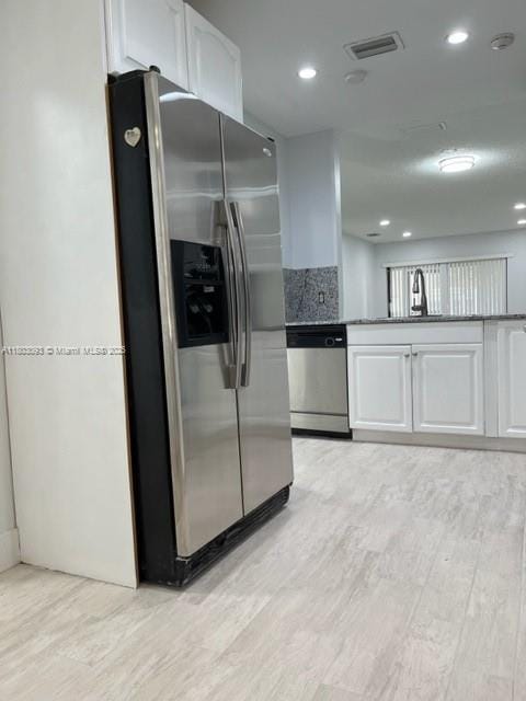 447 Lakeview Dr Unit 5, Weston, FL 33326 - kitchen with appliances with stainless steel finishes, light wood-style flooring, white cabinets, tasteful backsplash, and recessed lighting