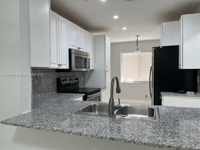 447 Lakeview Dr Unit 5, Weston, FL 33326 - kitchen featuring appliances with stainless steel finishes, a sink, white cabinets, backsplash, and recessed lighting