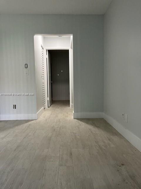 447 Lakeview Dr Unit 5, Weston, FL 33326 - empty room featuring baseboards and wood finished floors