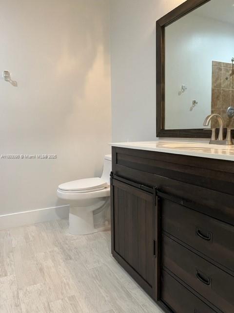 447 Lakeview Dr Unit 5, Weston, FL 33326 - bathroom with toilet, baseboards, and vanity