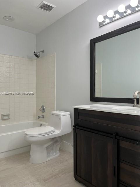 447 Lakeview Dr Unit 5, Weston, FL 33326 - bathroom featuring toilet, shower / bath combination, vanity, and wood finished floors