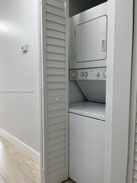 447 Lakeview Dr Unit 5, Weston, FL 33326 - laundry room with stacked washer / dryer and baseboards