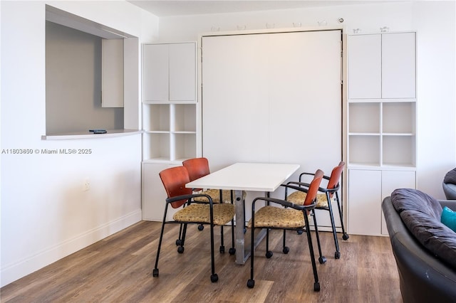 dining area with wood finished floors and baseboards