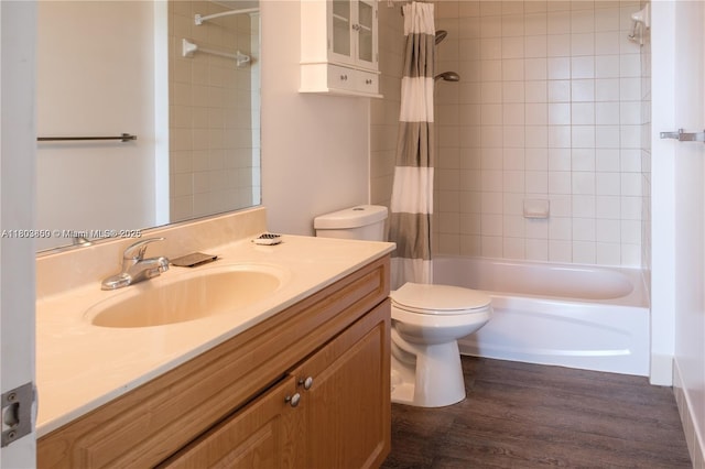 full bathroom with toilet, shower / tub combo with curtain, vanity, and wood finished floors