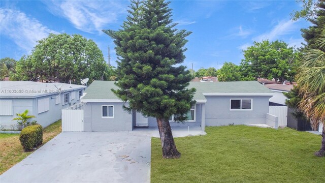 7917 Kismet St, Miramar, FL 33023 - ranch-style home featuring concrete driveway, a front yard, and stucco siding