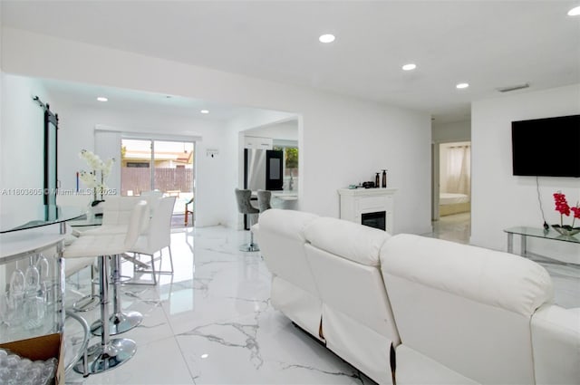 7917 Kismet St, Miramar, FL 33023 - living room featuring light marble finish flooring, recessed lighting, and a glass covered fireplace