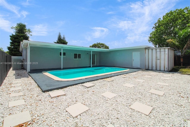 7917 Kismet St, Miramar, FL 33023 - view of pool with a fenced backyard, a patio, a storage unit, and an outbuilding