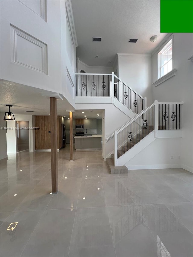 16247 SW 46th Ter, Miami, FL 33185 - foyer entrance with a high ceiling, stairway, crown molding, tile patterned flooring, and a textured ceiling
