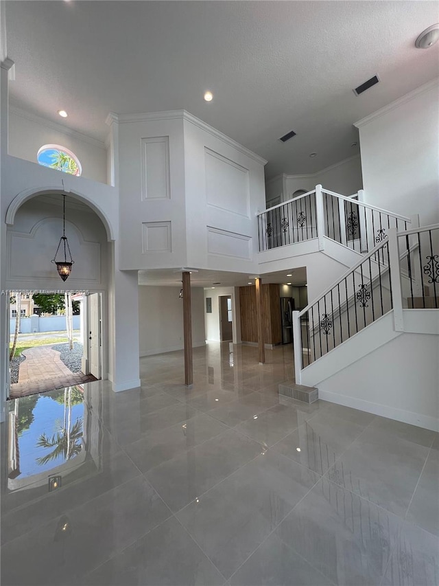 16247 SW 46th Ter, Miami, FL 33185 - unfurnished living room with a high ceiling, ornamental molding, stairs, tile patterned flooring, and recessed lighting