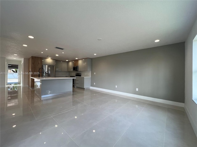 16247 SW 46th Ter, Miami, FL 33185 - unfurnished living room with baseboards, light tile patterned floors, a textured ceiling, and recessed lighting