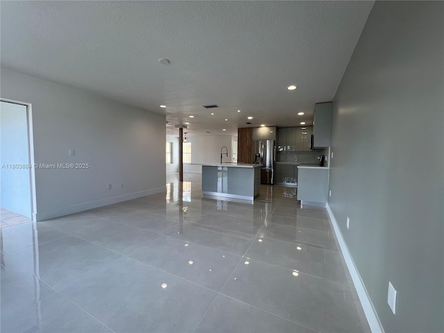 16247 SW 46th Ter, Miami, FL 33185 - unfurnished living room with a sink, light tile patterned floors, baseboards, recessed lighting, and a textured ceiling