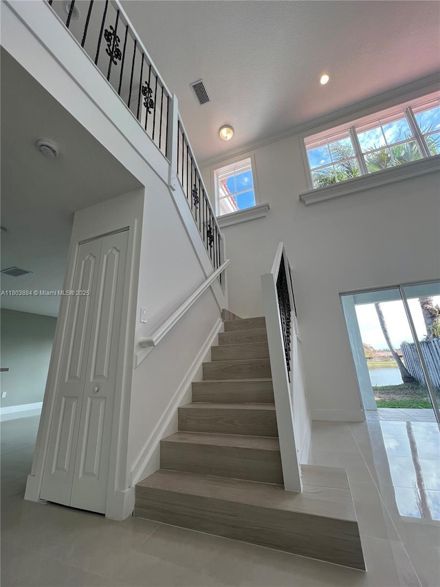 16247 SW 46th Ter, Miami, FL 33185 - stairway featuring tile patterned flooring, baseboards, recessed lighting, and a high ceiling