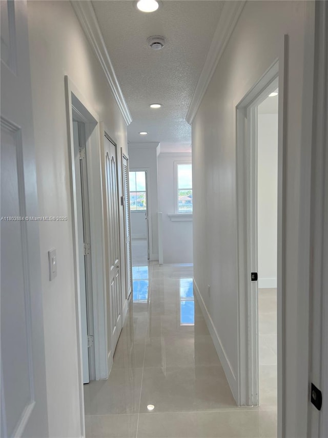 16247 SW 46th Ter, Miami, FL 33185 - hall featuring crown molding, a textured ceiling, baseboards, recessed lighting, and light tile patterned floors