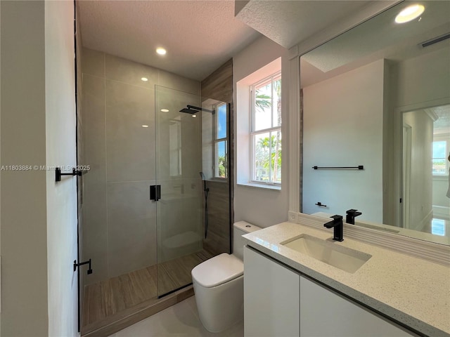 16247 SW 46th Ter, Miami, FL 33185 - full bath featuring toilet, a stall shower, healthy amount of natural light, a textured ceiling, and recessed lighting