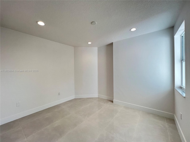 16247 SW 46th Ter, Miami, FL 33185 - empty room with a textured ceiling, recessed lighting, light tile patterned flooring, and baseboards