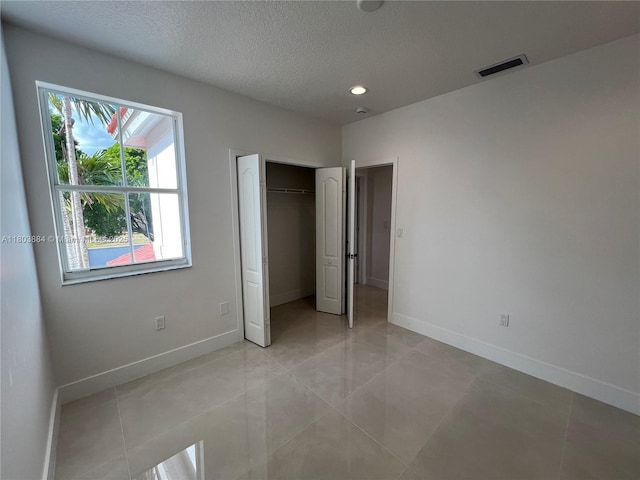 16247 SW 46th Ter, Miami, FL 33185 - unfurnished bedroom with a textured ceiling, baseboards, light tile patterned floors, a closet, and recessed lighting
