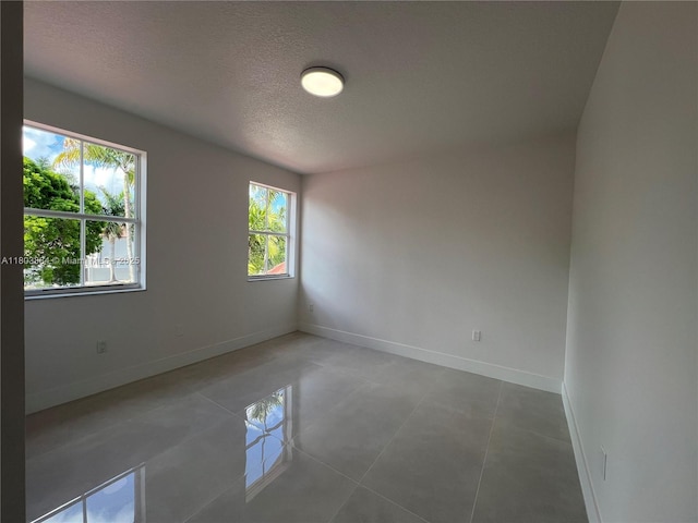 16247 SW 46th Ter, Miami, FL 33185 - unfurnished room featuring a textured ceiling, baseboards, and tile patterned flooring