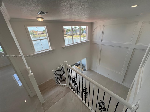 16247 SW 46th Ter, Miami, FL 33185 - staircase with plenty of natural light, a textured ceiling, recessed lighting, a water view, and tile patterned floors
