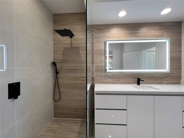 16247 SW 46th Ter, Miami, FL 33185 - bathroom featuring tile walls, tiled shower, and vanity