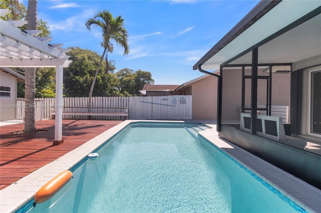 9813 SW 57th St, Cooper City, FL 33328 - view of swimming pool featuring a deck, a fenced backyard, and a pergola