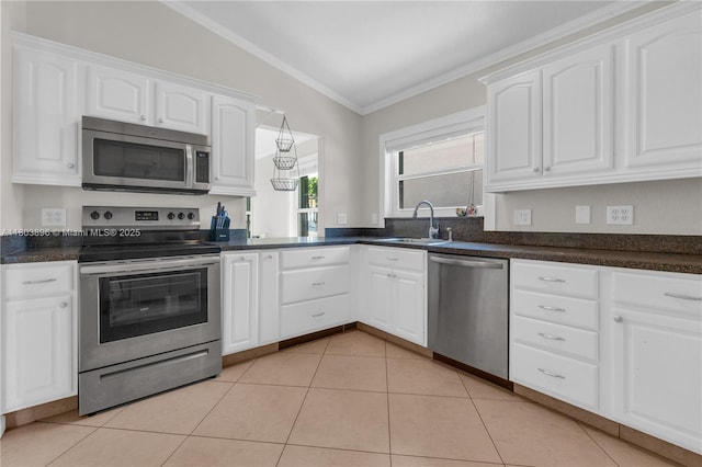 9813 SW 57th St, Cooper City, FL 33328 - kitchen featuring appliances with stainless steel finishes, vaulted ceiling, a sink, ornamental molding, and white cabinets