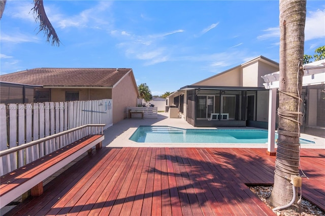 9813 SW 57th St, Cooper City, FL 33328 - view of pool with a sunroom, a wooden deck, and a fenced backyard