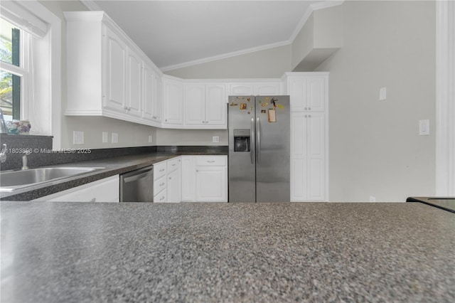 9813 SW 57th St, Cooper City, FL 33328 - kitchen featuring appliances with stainless steel finishes, vaulted ceiling, white cabinets, ornamental molding, and dark countertops