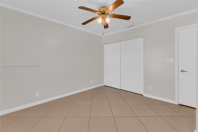 9813 SW 57th St, Cooper City, FL 33328 - unfurnished bedroom with crown molding, baseboards, light tile patterned flooring, a closet, and ceiling fan