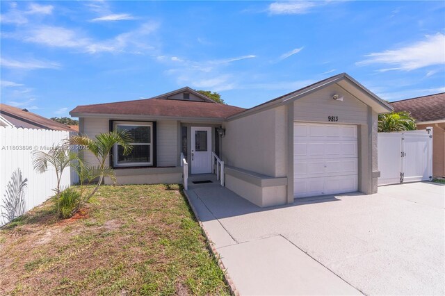 9813 SW 57th St, Cooper City, FL 33328 - view of front of property featuring an attached garage, fence, concrete driveway, and a gate