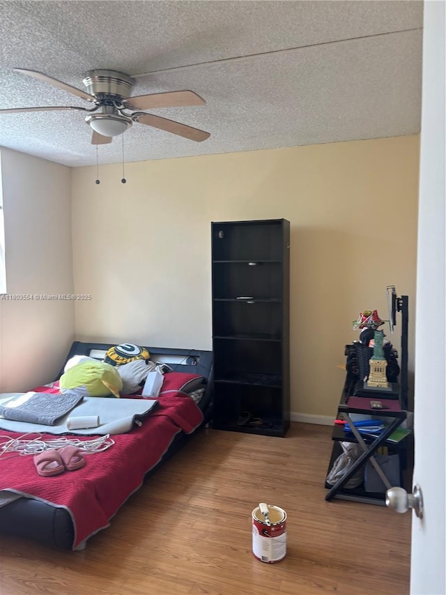 1820 N 81st Ave Unit 3310, North Lauderdale, FL 33068 - bedroom featuring wood finished floors, a textured ceiling, a ceiling fan, and baseboards