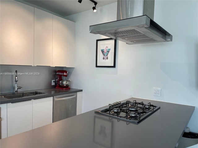 1618 Michigan Ave Unit 26, Miami Beach, FL 33139 - kitchen with exhaust hood, stainless steel dishwasher, black gas cooktop, dark countertops, and white cabinetry